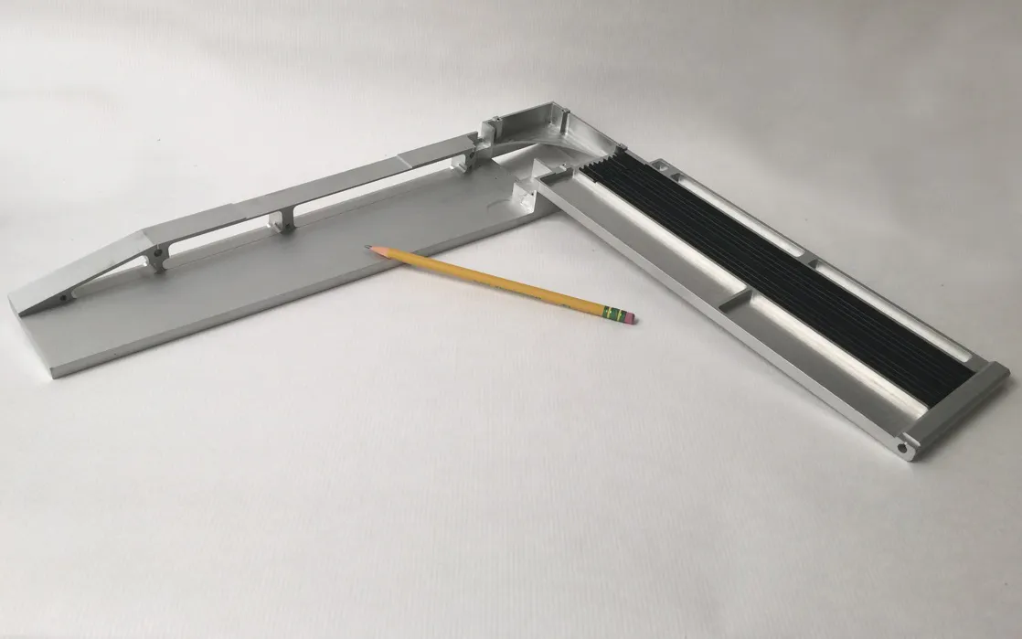 Long machined aluminum rail with a black strip insert, 1223 × 295 × 92 mm, with a pencil for scale